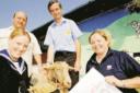 Linda Hodgson, Patrick Neal (BNS), David Gallacher and Claire McGowan (IMES Group) hand over the cheque and some straw to Honey the Goat