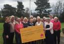 The club members present the cheque to the Glasgow centre's fundraising manager, Heather McArthur