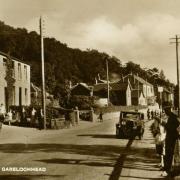 Garelochhead on a fine summer’s evening in the 1930s. On the left, and partly cut-off in 
the picture, is Inkerman Place, a tenement with shops on the ground floor, and residential 
accommodation above.