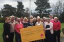 The club members present the cheque to the Glasgow centre's fundraising manager, Heather McArthur