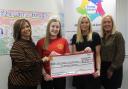 Junior captain Sophie presenting the donation to Helensburgh and Lomond Carers