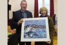 Karen Livingstone with judge James Auld and her winning painting from one of the club's 2021 competitions