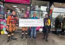 The cheque was presented to  presented to rescue boat members with Andrew, the owner of Loch Lomond News, the main outlet for the Loch Lomond Shores anniversary calendar sales.