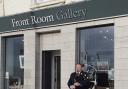 David Bruce, artist, playing the bagpipes outside the gallery at the opening event