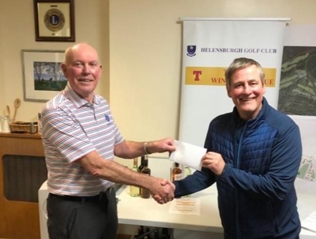 Convener Ivor Jones presents the final week's first place prize to Graham Thorley, one half of the winning pair