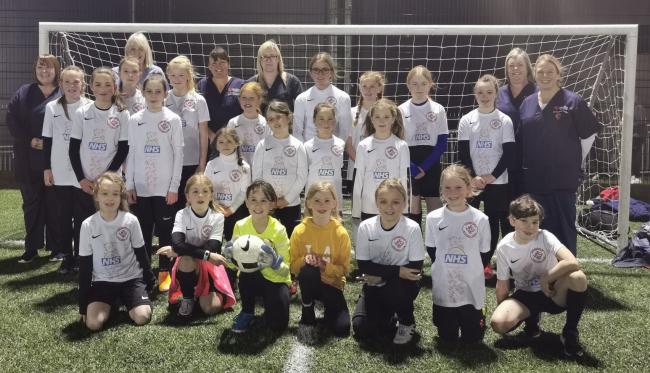 Ardencaple FC's girls' team in their new 'Thank You NHS' kit alongside staff from the Millig Practice and Dr McLachlan and Partners