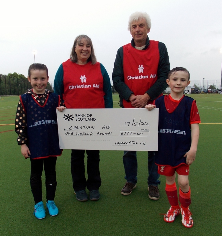 Ardencaple players present a cheque to Ellen Lambert and John Hanks from the local Christian Aid committee