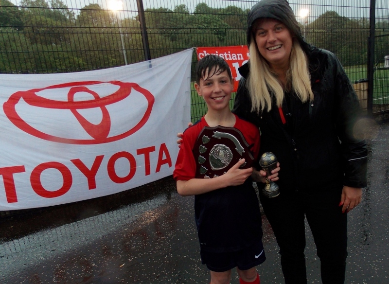 Player of the Tournament Harry MacDonald, captain of the winning Colgrain Primary Team, with Toyota's Kirsteen Don