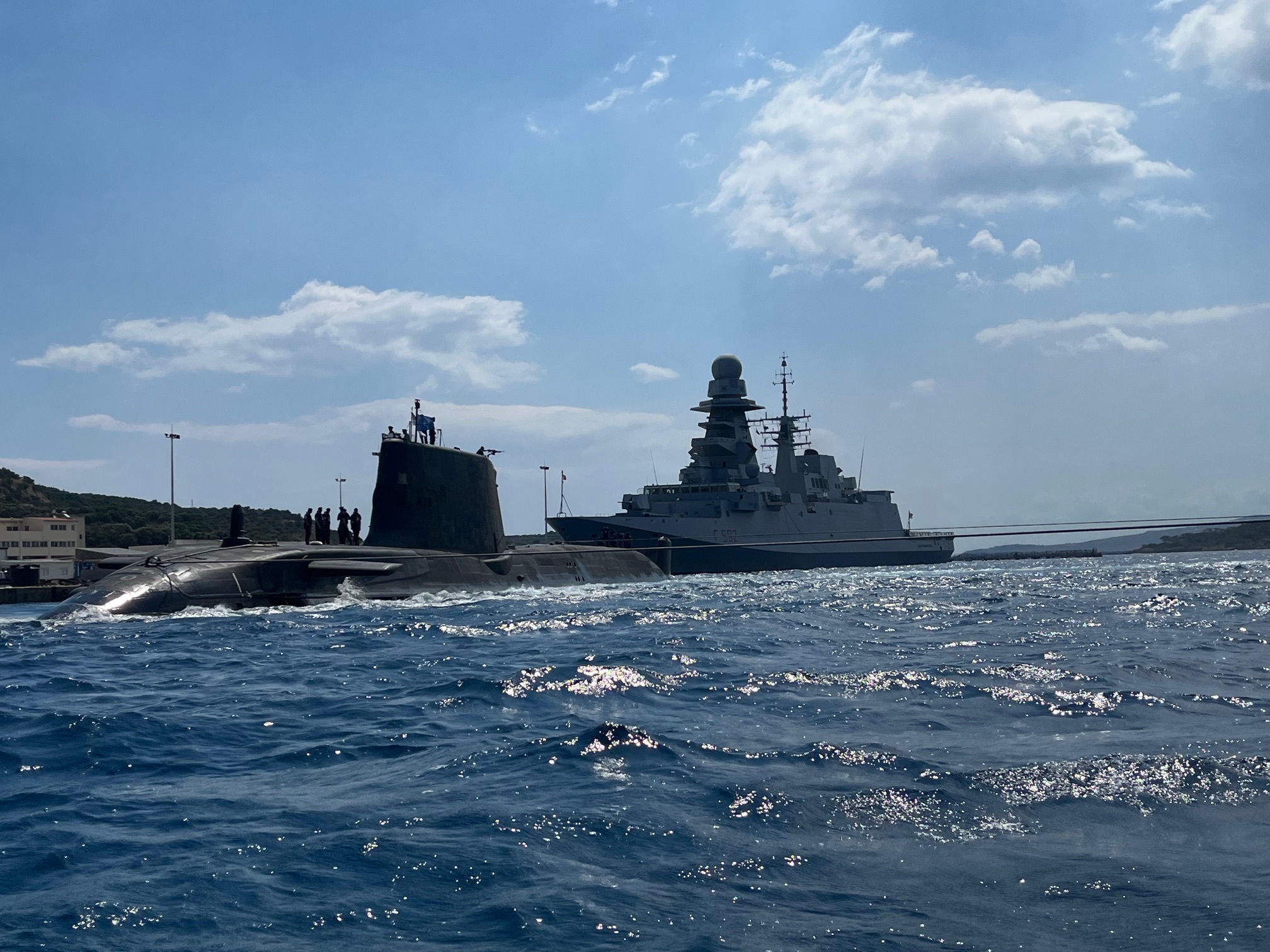 HMS Audacious departs Souda Bay in Crete ahead of NATO training and operations in the Mediterranean. The Astute-class submarine was on her first operational deployment from January 2022. The Italian frigate Carlo Margottini can be seen in the background.