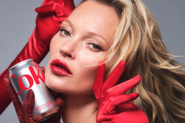 Kate Moss posing with a can of Diet Coke