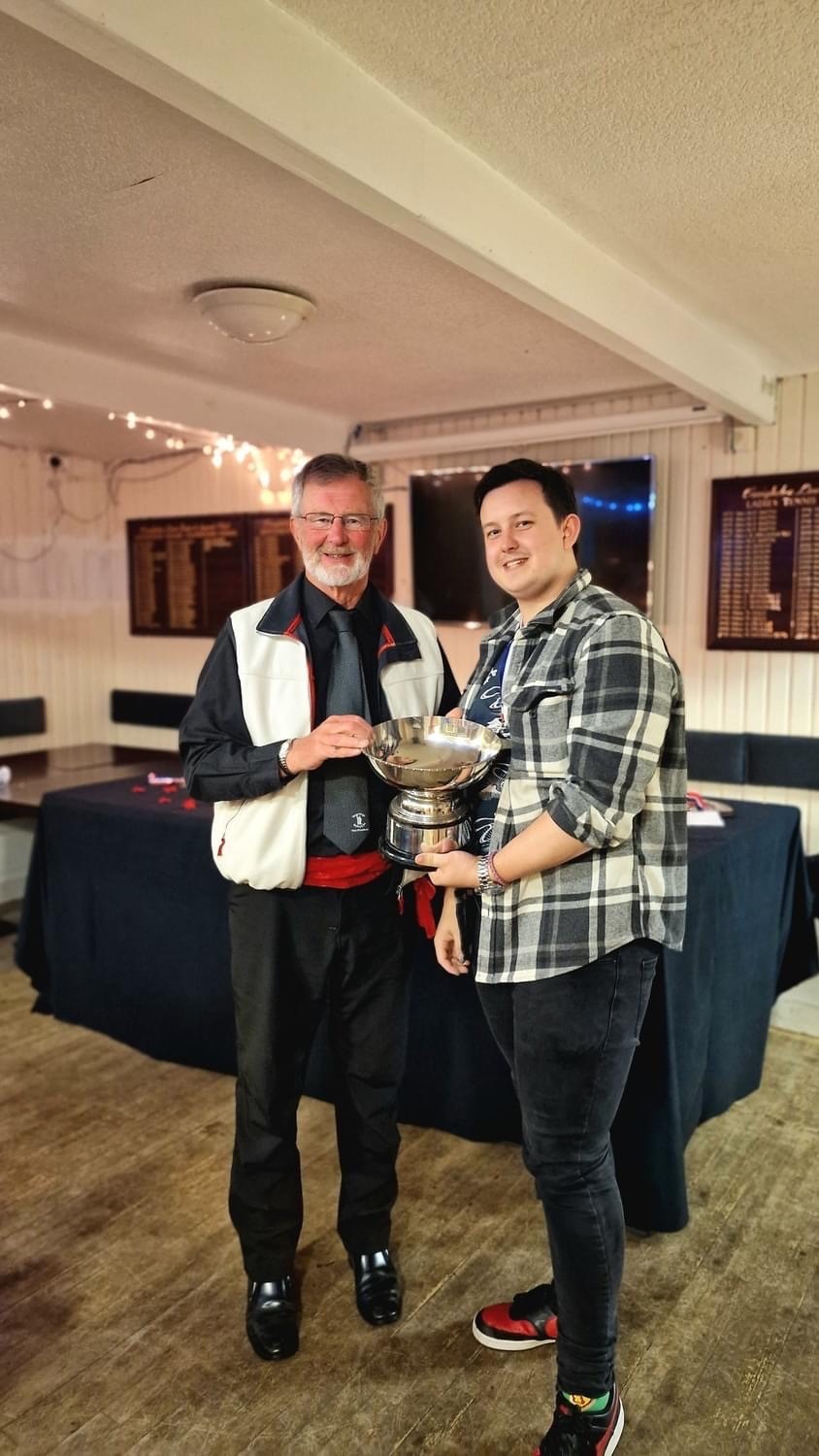 Honorary vice-president Richard Schooling presenting the players player of the year prize to Mark Findlay