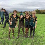 Helensburgh’s P6/P7 squad beat their Loch Lomond counterparts in ‘old school’ muddy conditions at Dillichip on Sunday (Photo - Mark Bone)