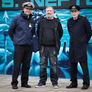 Commodore Bob Anstey, Naval Base Commander Clyde; Barry the Cat, otherwise known as Barry Jenkins; and Commander Peter Noblett, Base Executive Officer