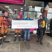The cheque was presented to  presented to rescue boat members with Andrew, the owner of Loch Lomond News, the main outlet for the Loch Lomond Shores anniversary calendar sales.