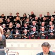 The choir singing, with conductor Susannah Wapshott and soloist David Stout