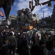 Palestinians examine the destruction after an Israeli strike on Rafah in the Gaza Strip (Image: AP Photo/Fatima Shbair)