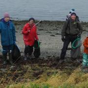 Partcipants (not pictured here) battled the windy weather to clean Rhu's beach